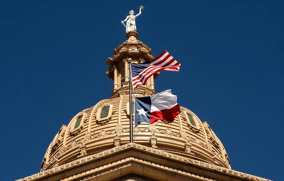 The dome of the Texas State Capitol against a clear blue sky, representing the foundation of the state's government.