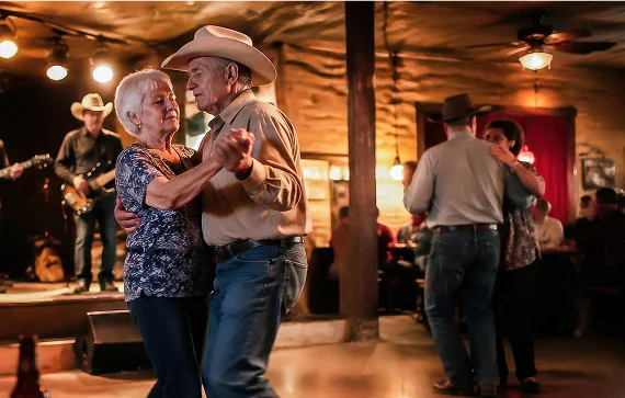 A couple in western wear two-steps in a dance hall, showcasing the vibrant and diverse culture of Texas people.