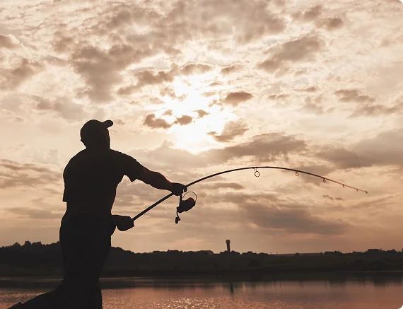 Illustration of a person fishing from a wooden dock, representing the recreational opportunities available with a license.
